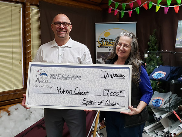 Anthony Rizk presenting the Spirit of Alaska 2020 Sponsorship Check to the Yukon Quest Director Marti Steury