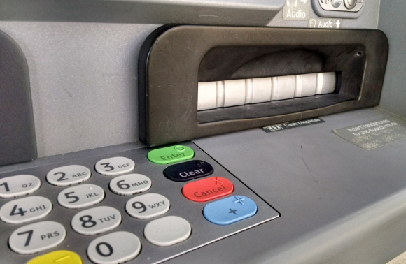 Image of an ATM pin pad and cash dispenser slot