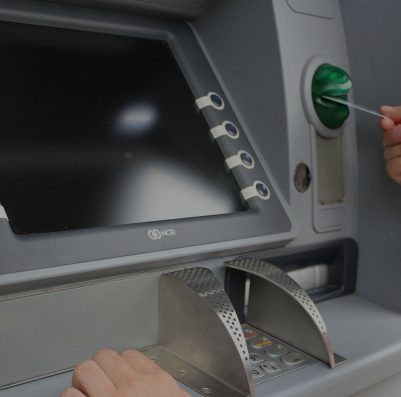a man putting a card into an ATM machine