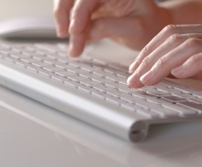 hands on a computer keyboard