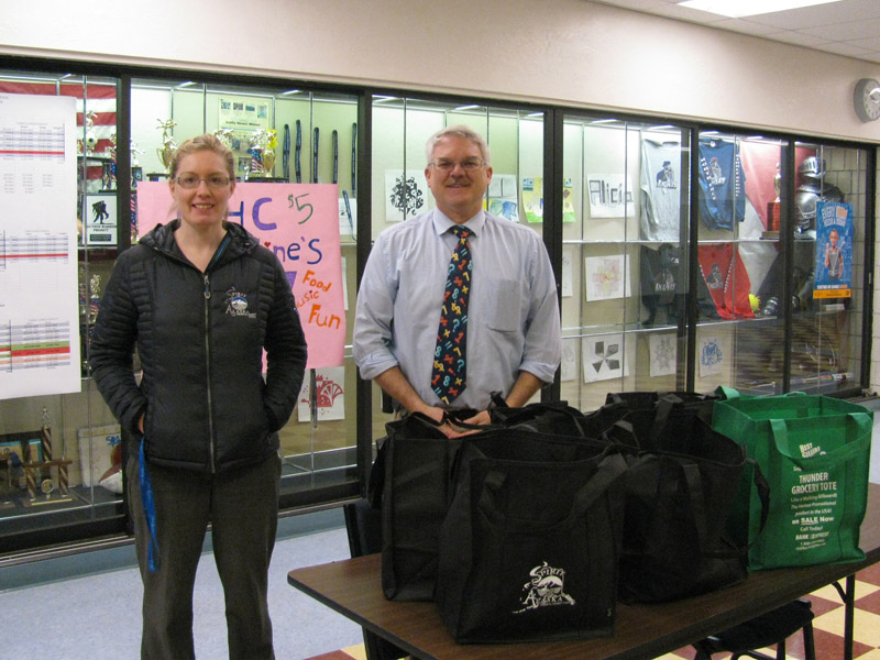 Food Pantry Donation to North Pole Middle School Principal Smith and Sarah Geer stand in front of a food donation to North Pole Middle School.