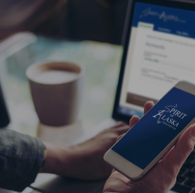 mockup image of person holding phone in front of computer